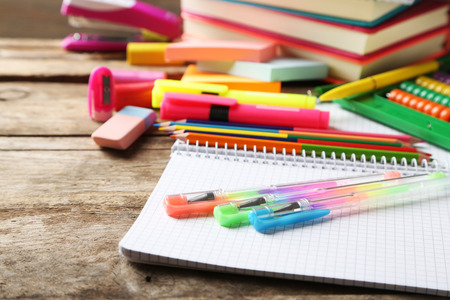 Bright school stationery on old wooden table