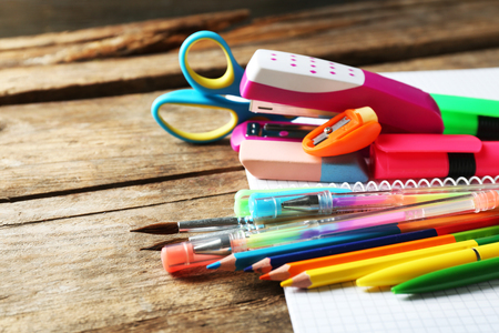 Bright school stationery on old wooden table