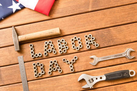 Labor day american flag different tools on wooden background