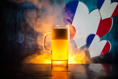 Soccer 2018 single beer glass on table at dark toned foggy background support france with beer concept selective focus