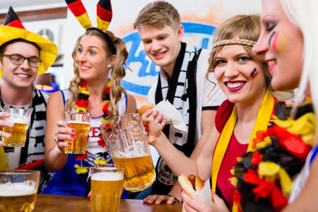 Football fans watching a game of the german national team drinking beer Stock Photo