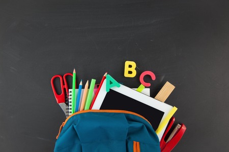 Back to school accessories for school on a dark background pencils plasticine letters letters briefcase chalk copy space top view