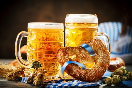 Beer mugs and pretzels on a wooden table oktoberfest beer festival Stock Photo