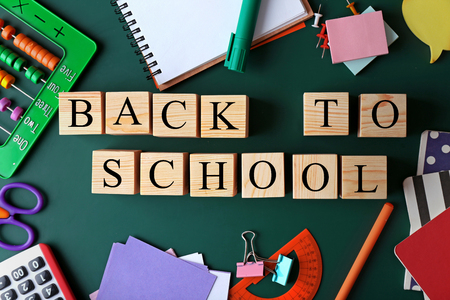 Colourful stationery and words back to school on chalkboard Stock Photo