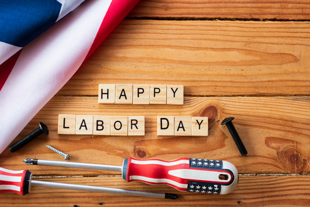 Usa labor day concept first monday in september different kinds on wrenches handy tools america flag and wooden blocks on wooden table