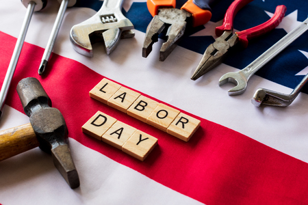 Usa labor day concept first monday in september different kinds on wrenches handy tools america flag and wooden blocks on wooden table