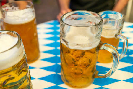 Close up of bavarian beer glasses 1 liter beer on table decoation at the octoberfest Stock Photo