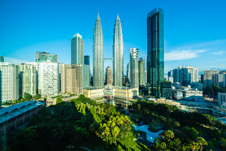 Beautiful architecture building exterior city in kuala lumpur skyline with white cloud and blue sky