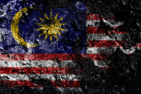 Malaysia smoky mystical flag on the old dirty wall background Stock Photo