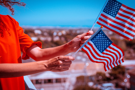 Woman hands with usa national flag celebrating american national holiday Stock Photo