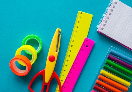 Stationery for study at school lies on blue