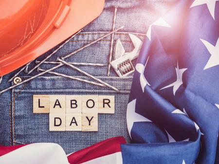 Labor day american flag wrench nails stylish jeans and wooden letters of the alphabet top view close up preparations for celebration congratulations for relatives friends and colleagues Stock Photo