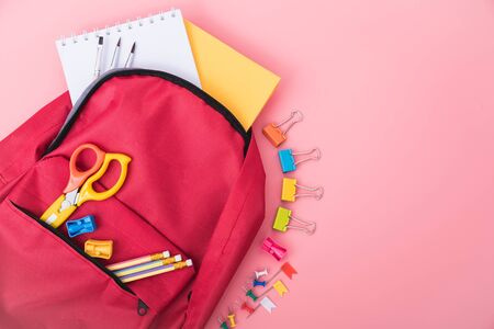 Top view red bag backpack for education children on pink background back to school concept