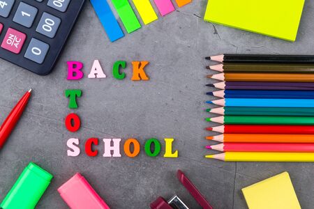 The layout of school supplies on a dark gray background the view from the top back to school flat lay