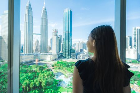 Young asian woman travel around kuala lumpur and looking the city in malaysia