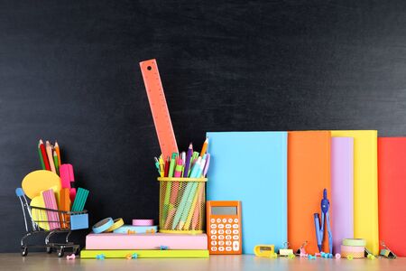 School supplies on blackboard background