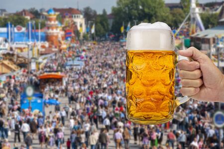 Big traditional glass of bavarian beer at oktoberfest in munich