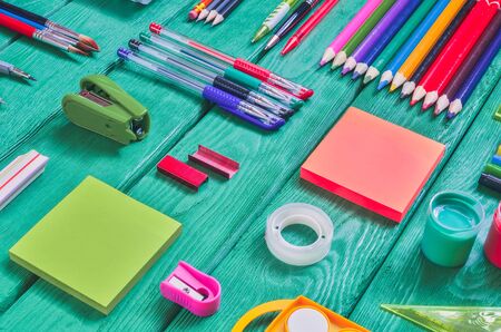 Creative school concept arranged school accessories on a green desk Stock Photo