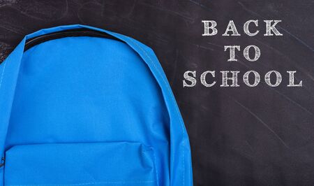 Back to school shopping pocket backpack on the education blue bag on blackboard and chalkboard