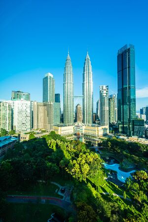 Beautiful architecture building exterior city in kuala lumpur skyline with white cloud and blue sky