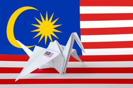 Malaysia flag depicted on paper origami crane wing oriental handmade arts concept