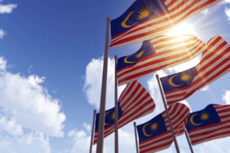 Malaysia flags waving in the wind against a blue sky 3d rendering