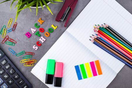 The layout of school supplies on a dark gray background the view from the top back to school flat lay