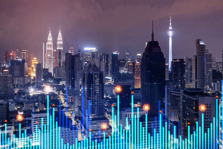 Stock market graph hologram night panorama city view of kuala lumpur kl is popular location to gain financial education in malaysia asia the concept of international research double exposure