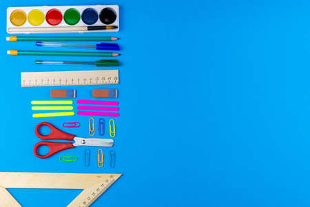 Back to school school accessories on a blue background photo banner top view space for text