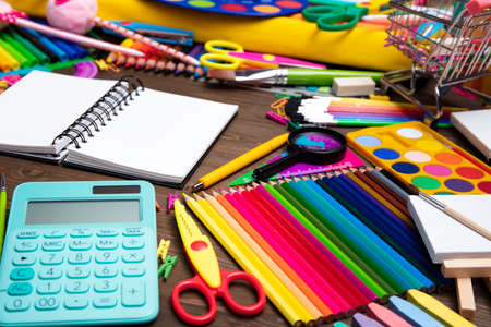 School supplies composition of colorful school accessories isolated on the brown table top view Stock Photo