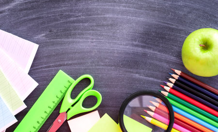 School supplies on a blackboard