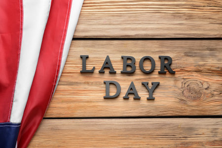 Usa flag and text labor day on wooden background