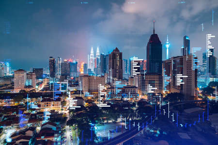 Stock market graph hologram night panorama city view of kuala lumpur kl is popular location to gain financial education in malaysia asia the concept of international research double exposure