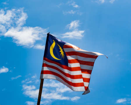 Malaysia flag waving against blue skies