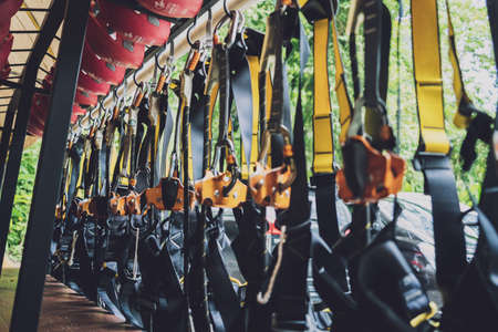 Rows of climbing safety ropes and carabiners and helmets Stock Photo