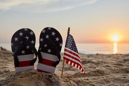 Labor day usa background with with flip flops on the sandy beach patriotic usa background