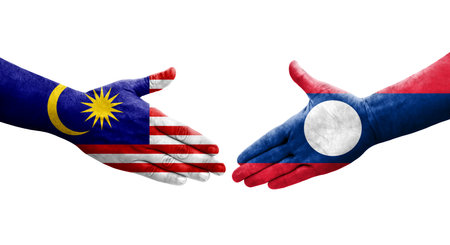 Handshake between laos and malaysia flags painted on hands isolated transparent image Stock Photo