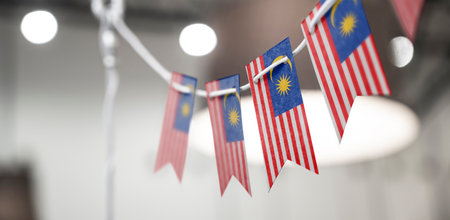 A garland of malaysia national flags on an abstract blurred background Stock Photo