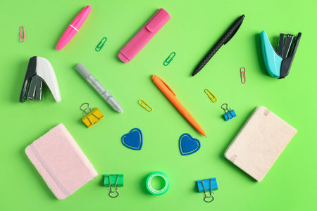 Composition with different stationery on green background Stock Photo