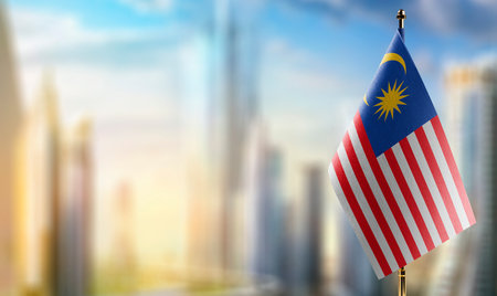 Small flags of the malaysia on an abstract blurry background Stock Photo