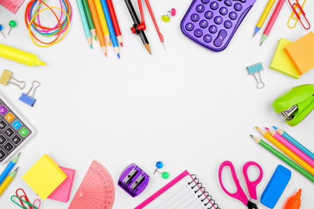 School supplies frame overhead view on a white background copy space back to school concept