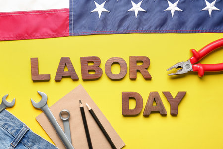 Composition with text labor day different tools jeans and usa flag on yellow background Stock Photo