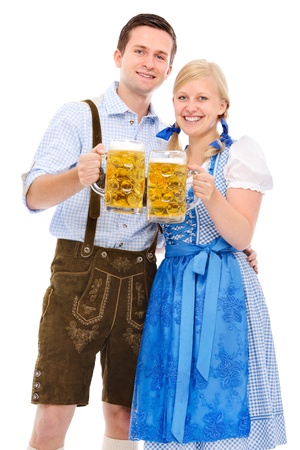 Happy bavarian couple in dirndl with oktoberfest beer Stock Photo