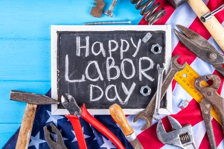 American national patriotic workers happy labor day holiday background construction and manufacturing tools on wooden background with stars red white blue striped us flag