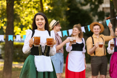 Young octoberfest waitress with beer outdoors Stock Photo