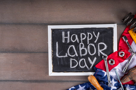 American national patriotic workers happy labor day holiday background construction and manufacturing tools on wooden background with stars red white blue striped us flag