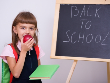 Cute girl is holding book school concept