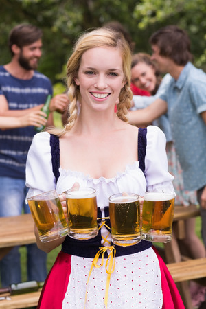 Pretty oktoberfest girl smiling at camera on a sunny day Stock Photo