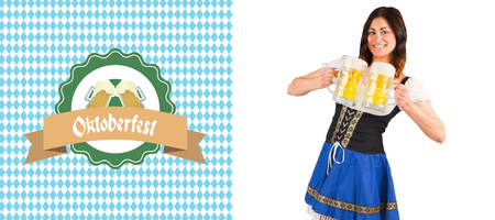 Pretty oktoberfest girl holding beer tankards against oktoberfest graphics