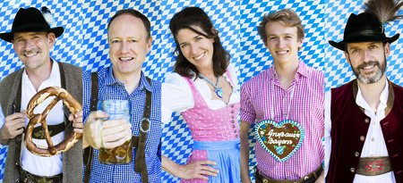 Multiple faces of people in traditional bavarian clothes